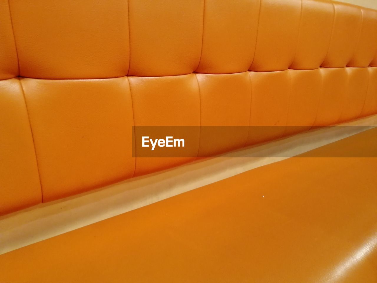 Full frame shot of orange sofa