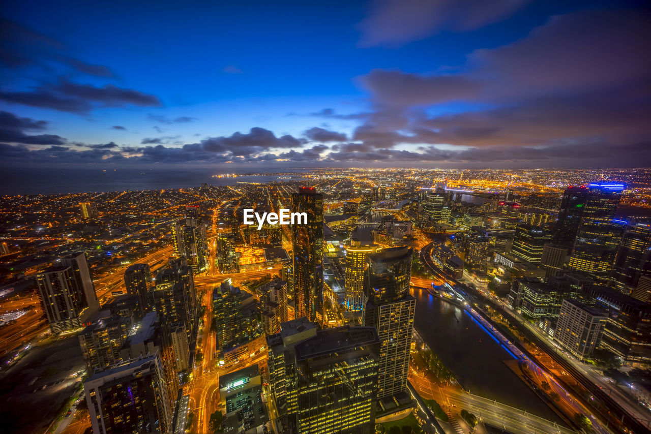 Aerial view of city lit up at night