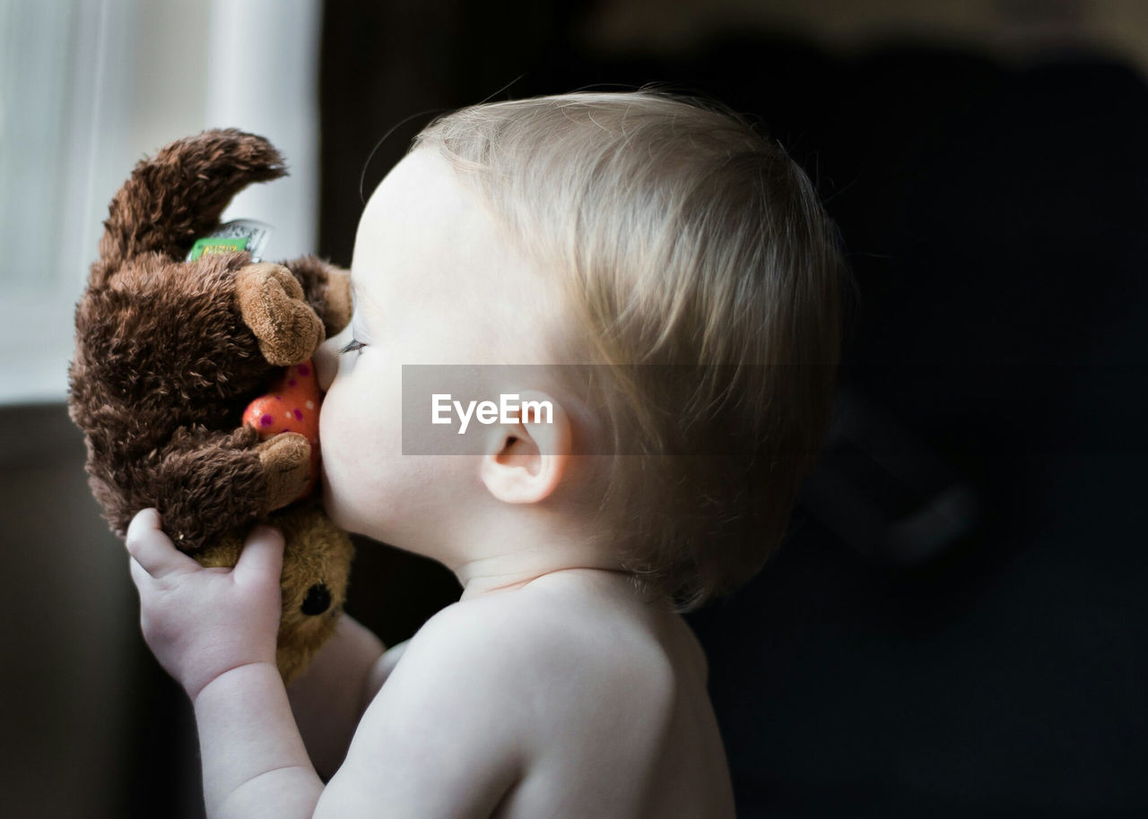 Close-up of cute baby with stuffed toy