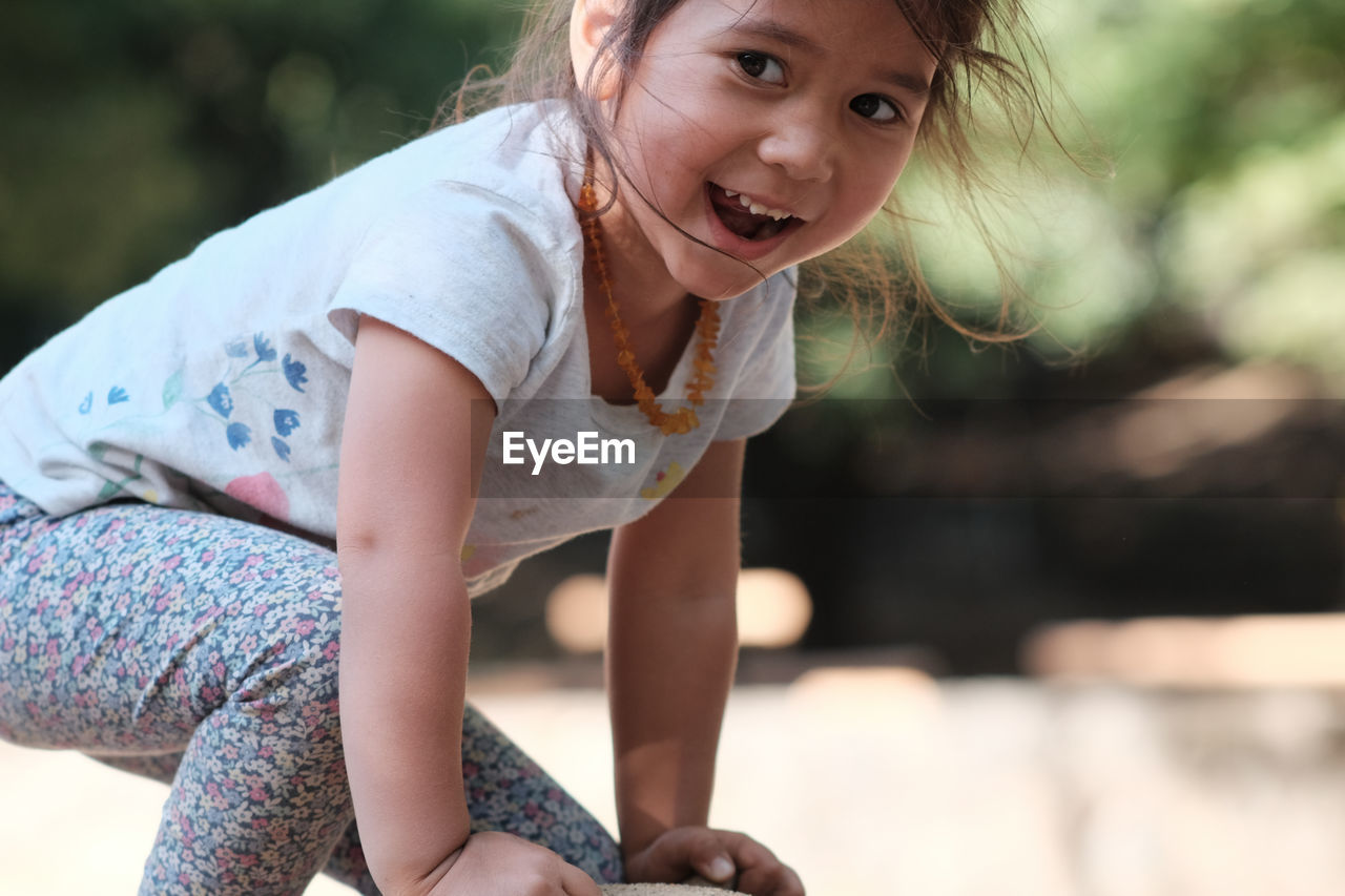 Close-up of happy girl playing in playground