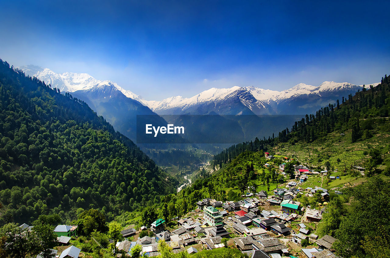 High angle view of trees and mountains against sky