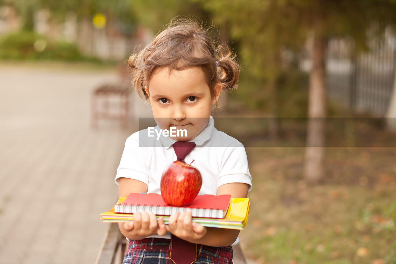 portrait of cute girl eating fruit