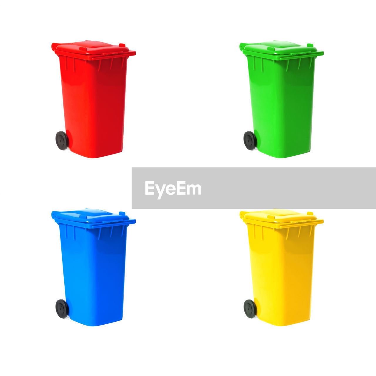 Close-up of multi colored garbage bin over white background
