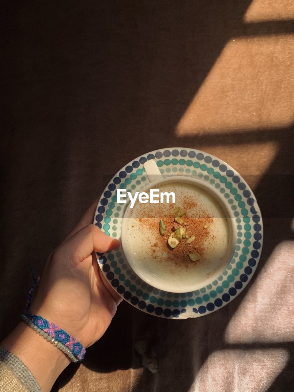 Directly above shot of woman holding dessert in plate