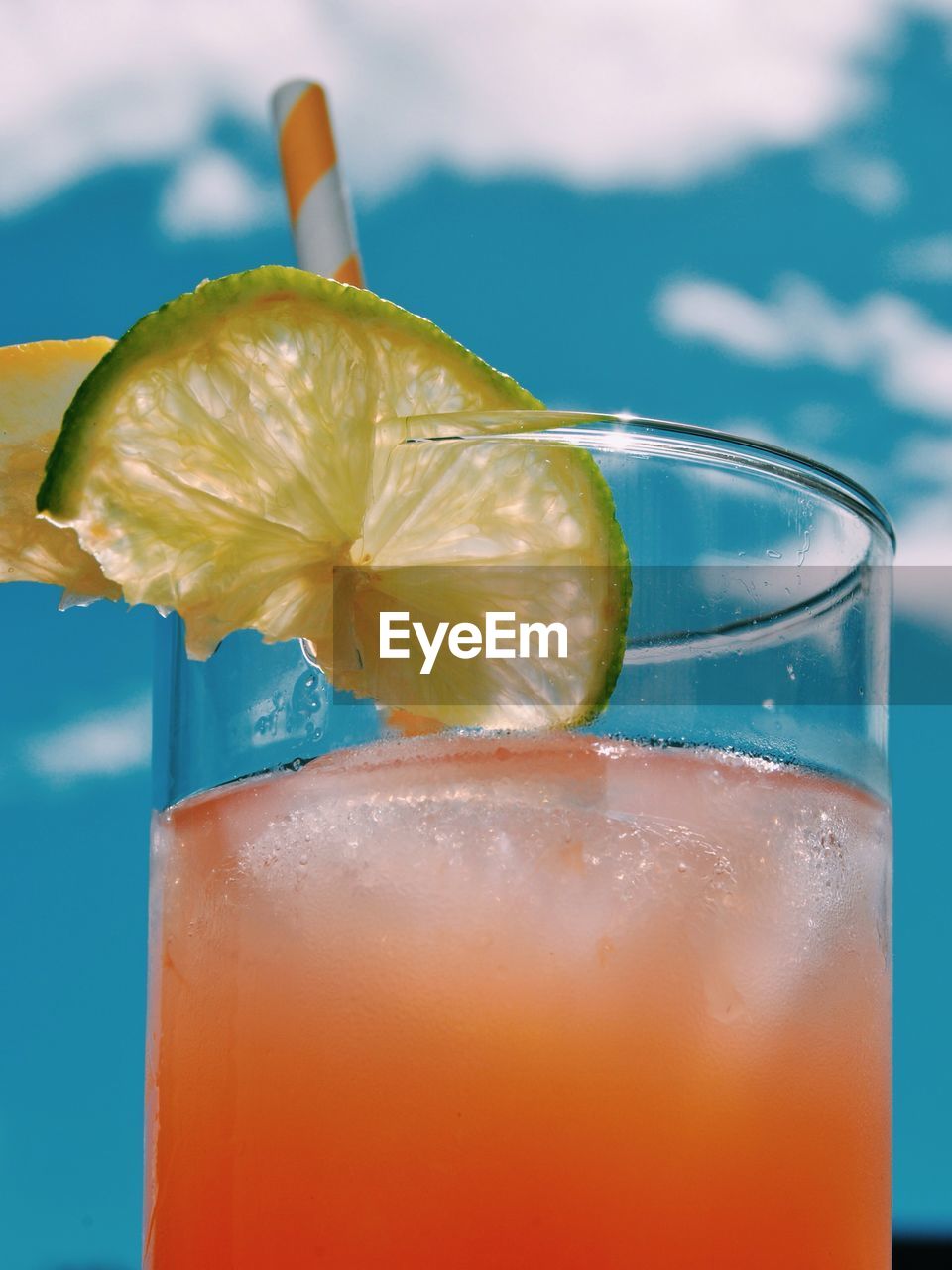 Close-up of cocktail served in glass against sky