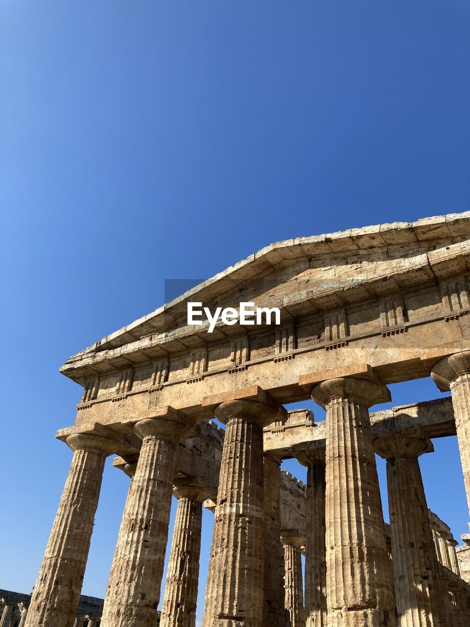 Low angle view of temple against clear blue sky