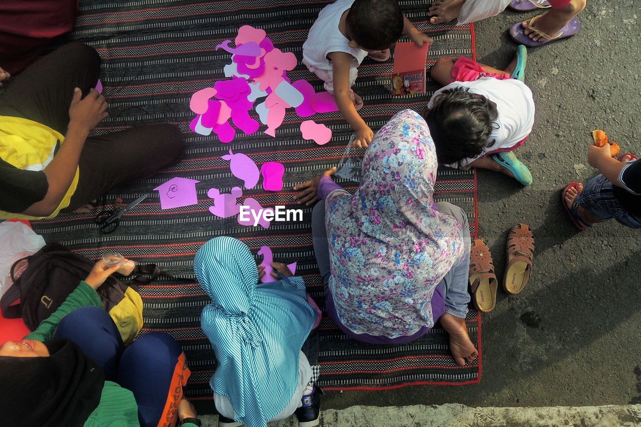 Directly above shot of people trying craft outdoors