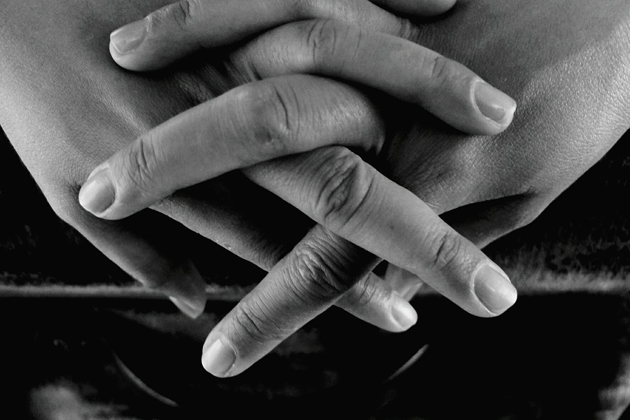 CLOSE-UP OF HANDS HOLDING BABY