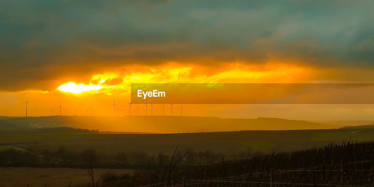 SCENIC VIEW OF DRAMATIC SKY OVER SILHOUETTE LANDSCAPE
