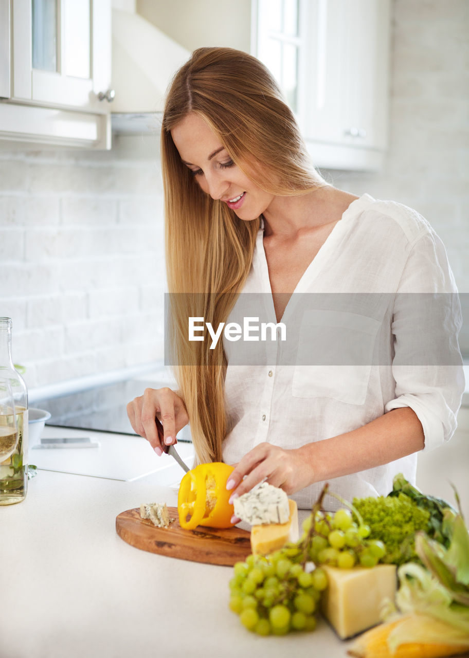 Young woman preparing food at home