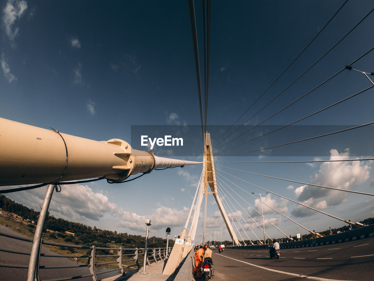 PEOPLE ON BRIDGE IN CITY AGAINST SKY