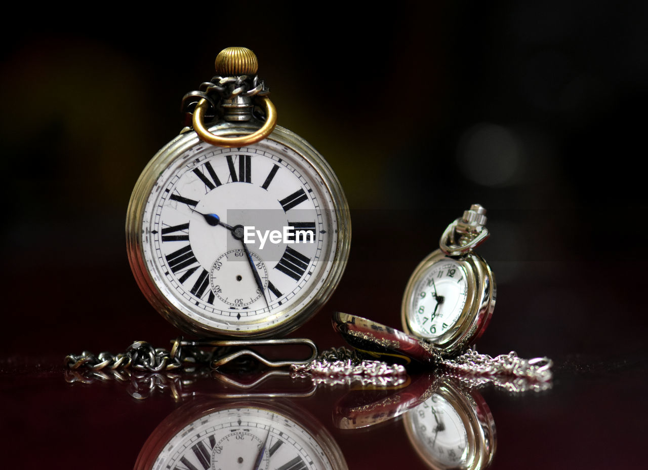 Close-up of pocket watches on table