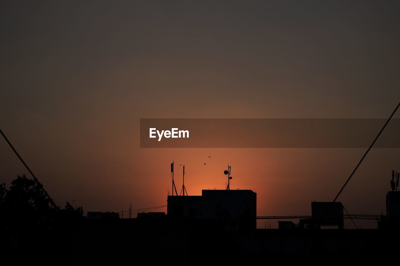 Silhouette birds against sky during sunset