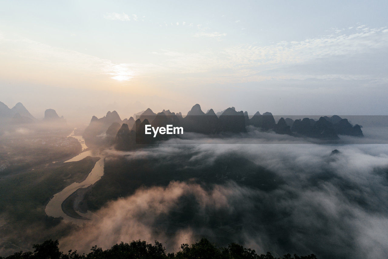 Mountain peaks under sky at sunrise, guilin, china