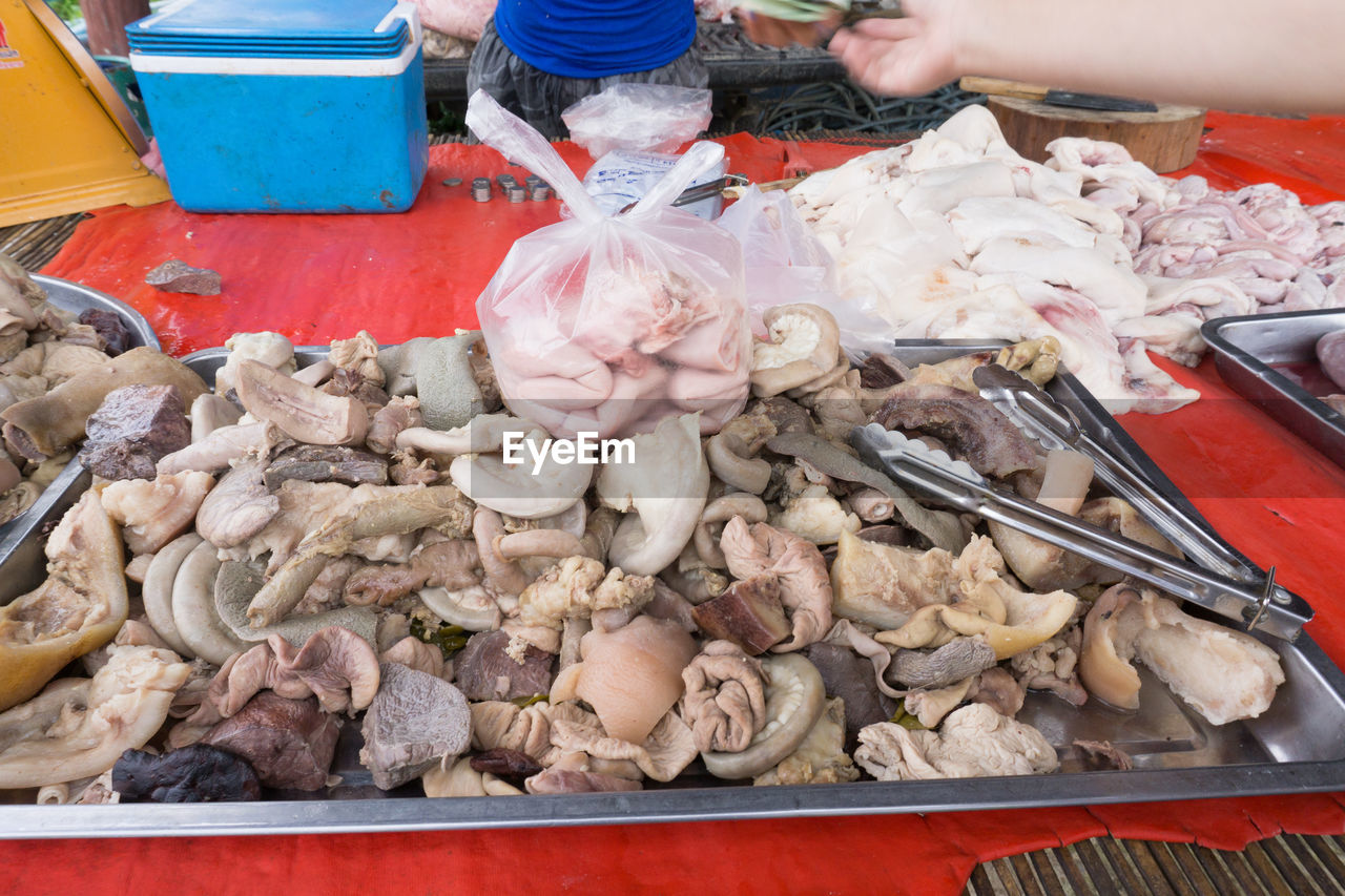 Cropped image of person holding meat at table