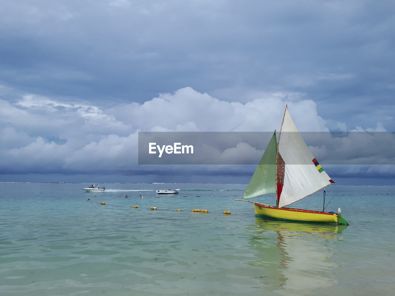 Sailboat in sea against sky