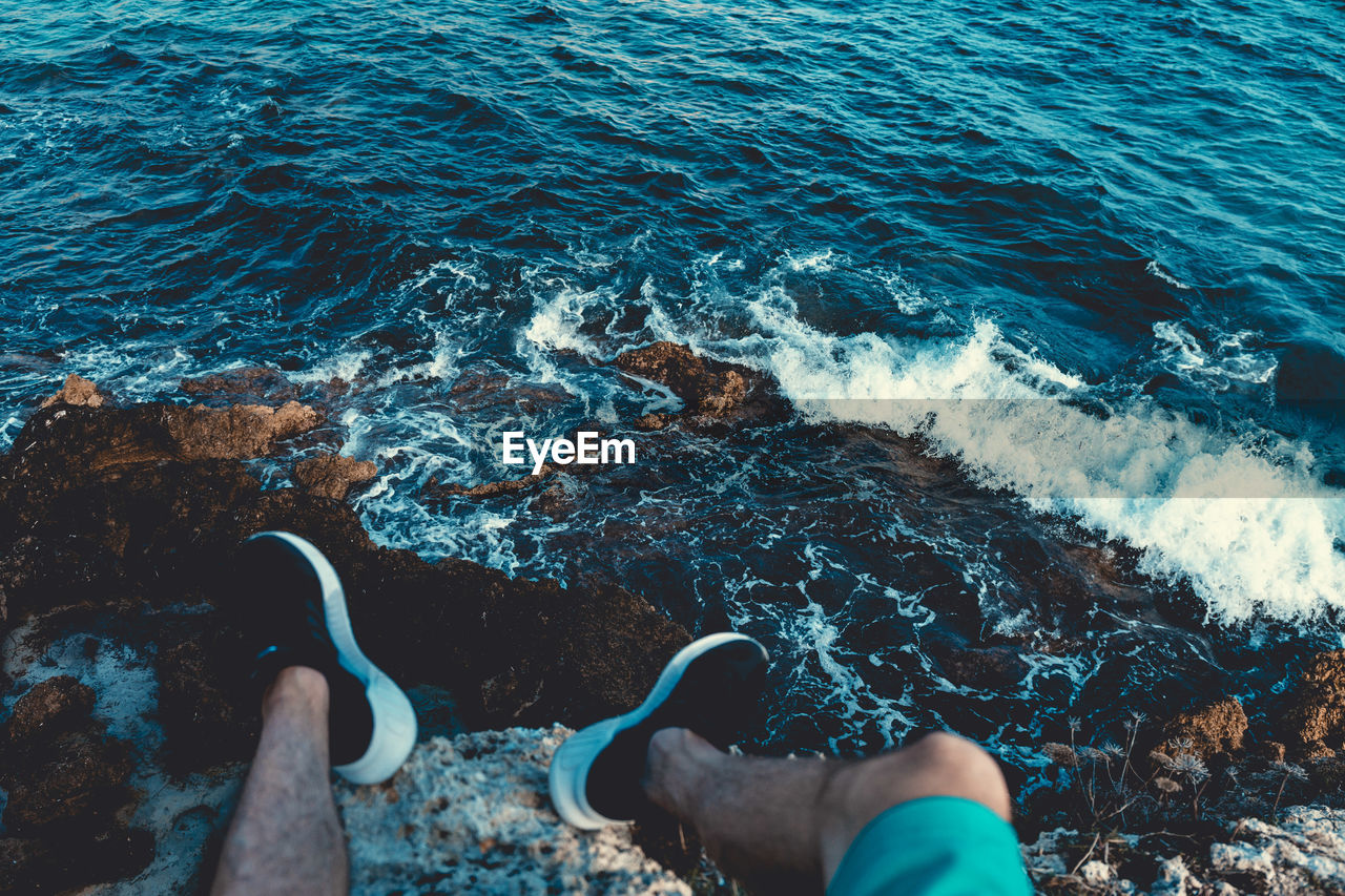 HIGH ANGLE VIEW OF HANDS IN WATER