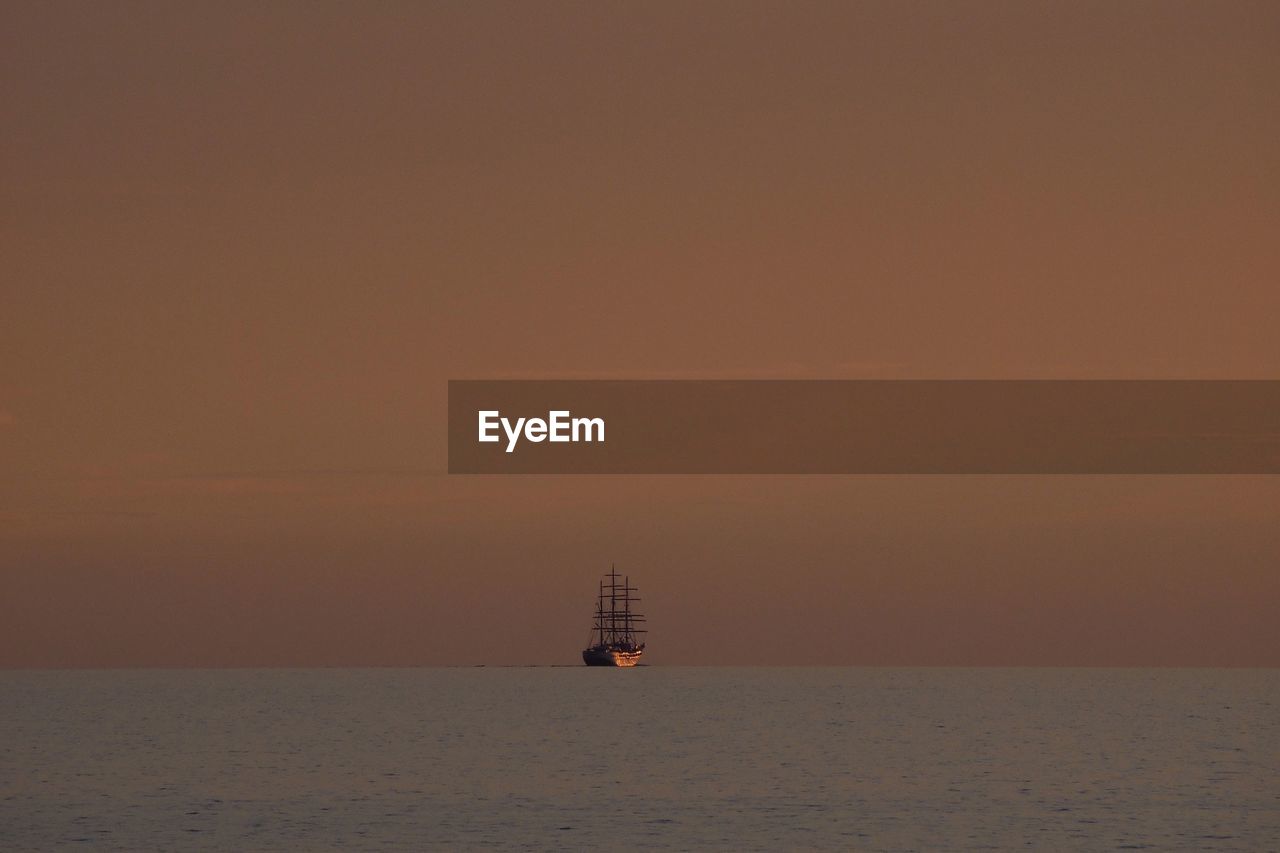 Ship sailing in baltic sea during sunset