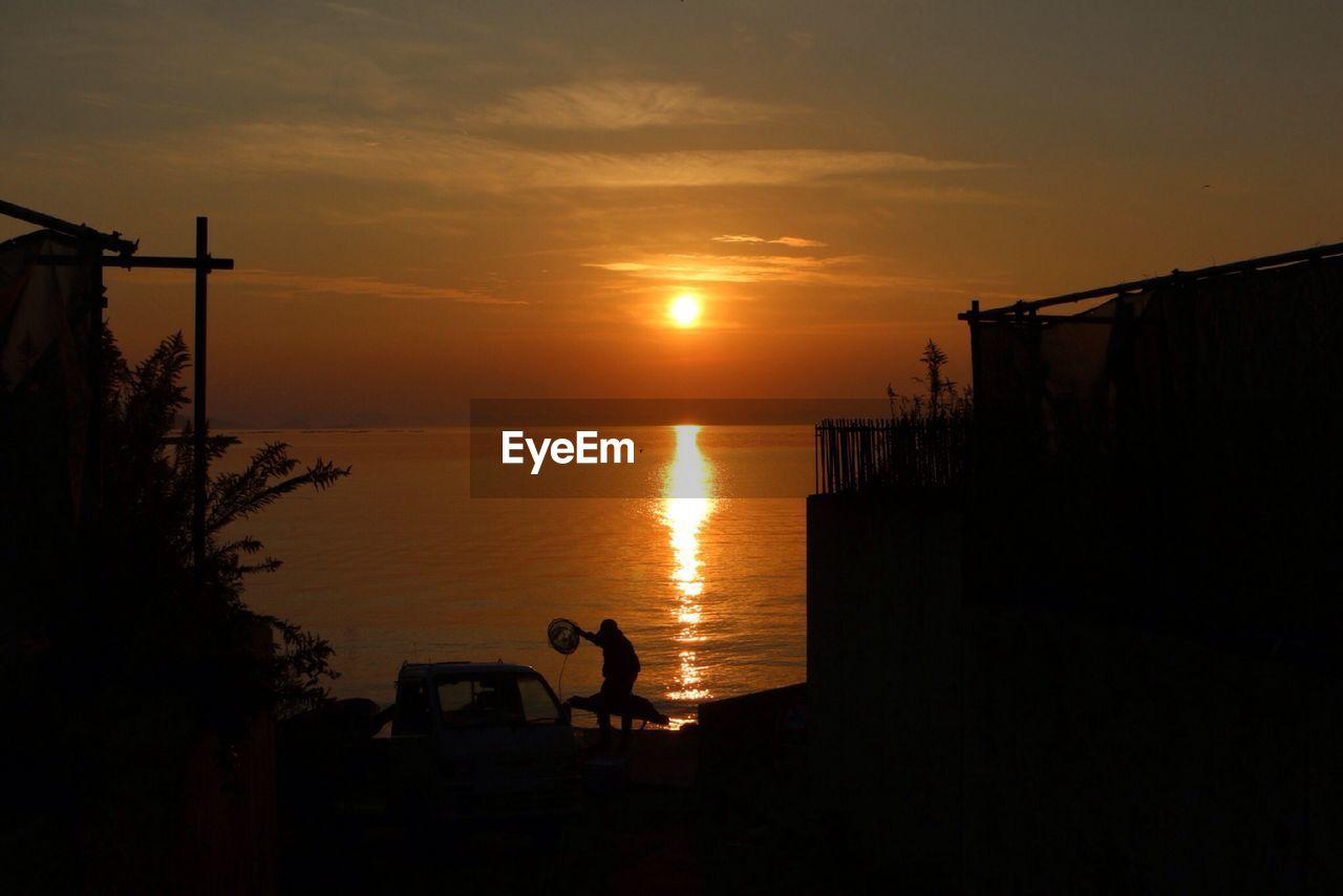 Scenic view of sea against orange sky