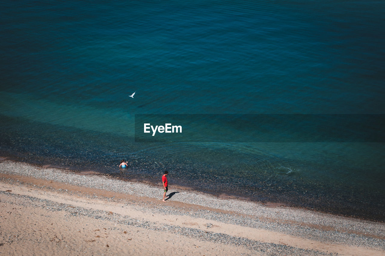 Man standing on beach against sky