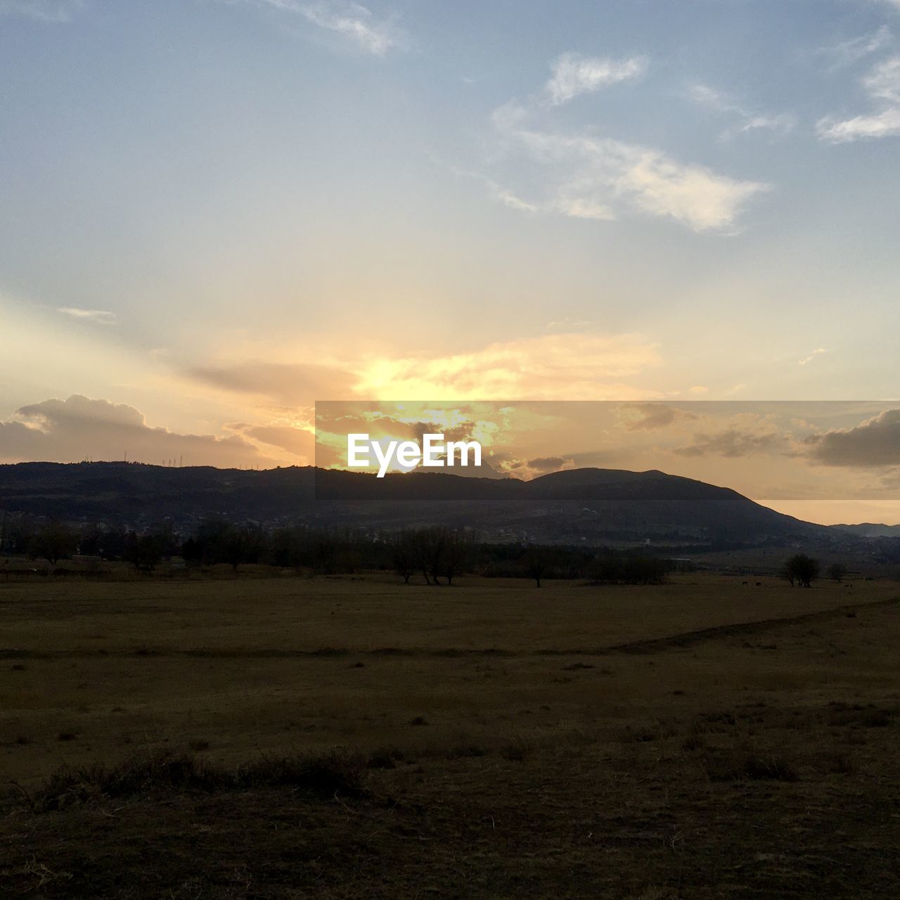 FIELD AGAINST SKY DURING SUNSET