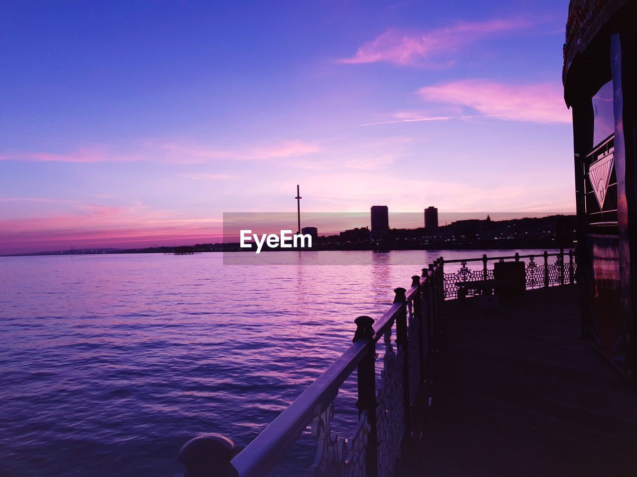 Balcony over sea against sky during sunset