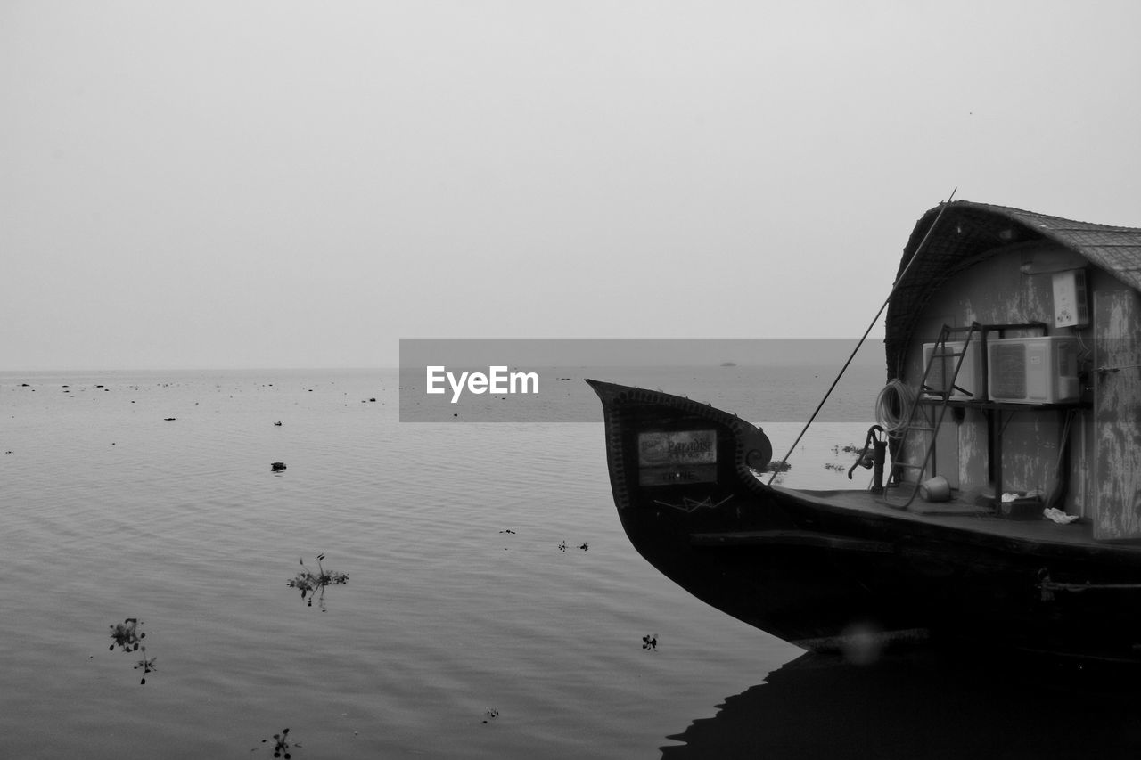 Houseboat on lake during foggy weather