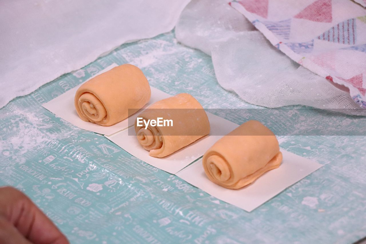 Close-up of rolled dough side by side on table