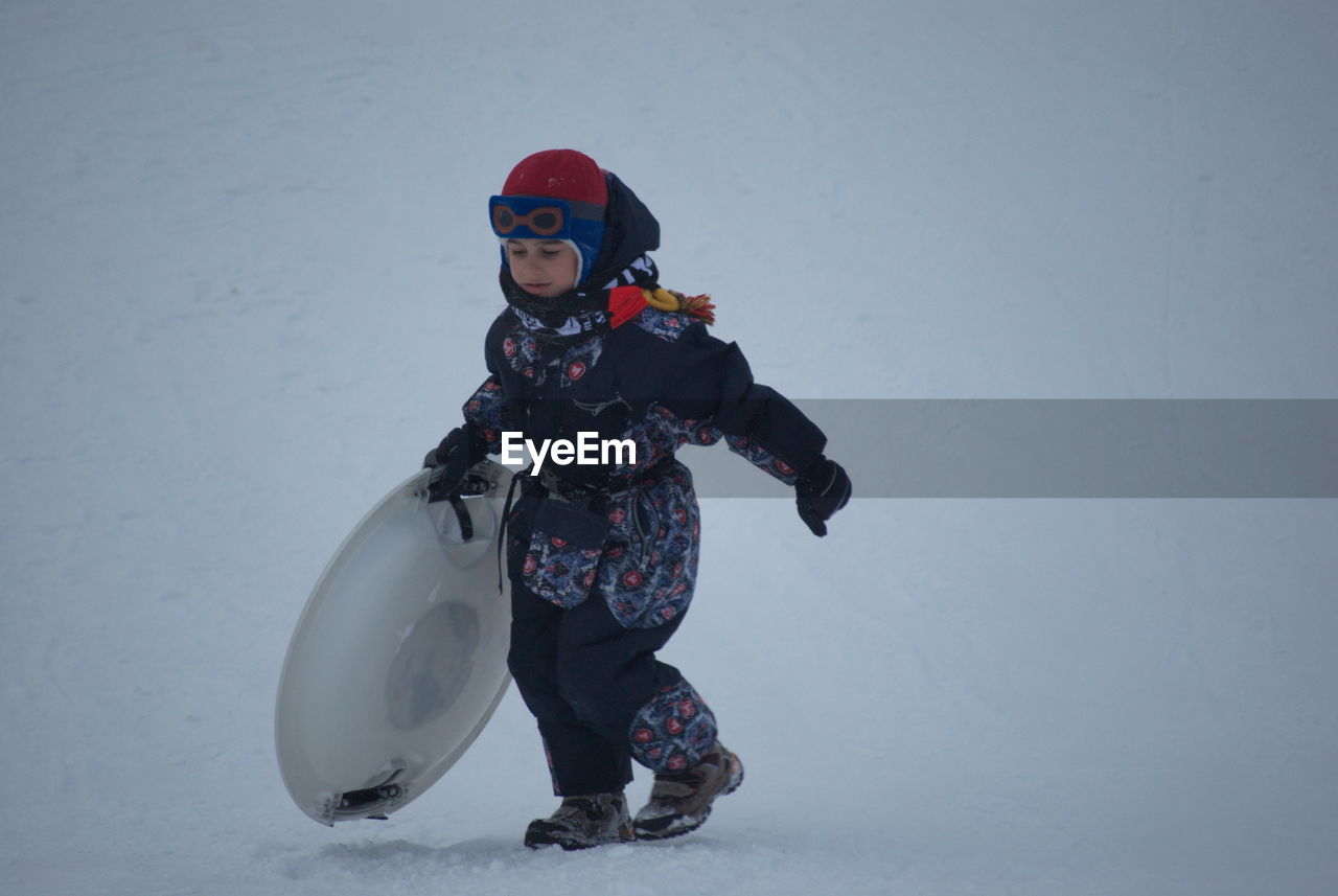 MAN STANDING IN SNOW