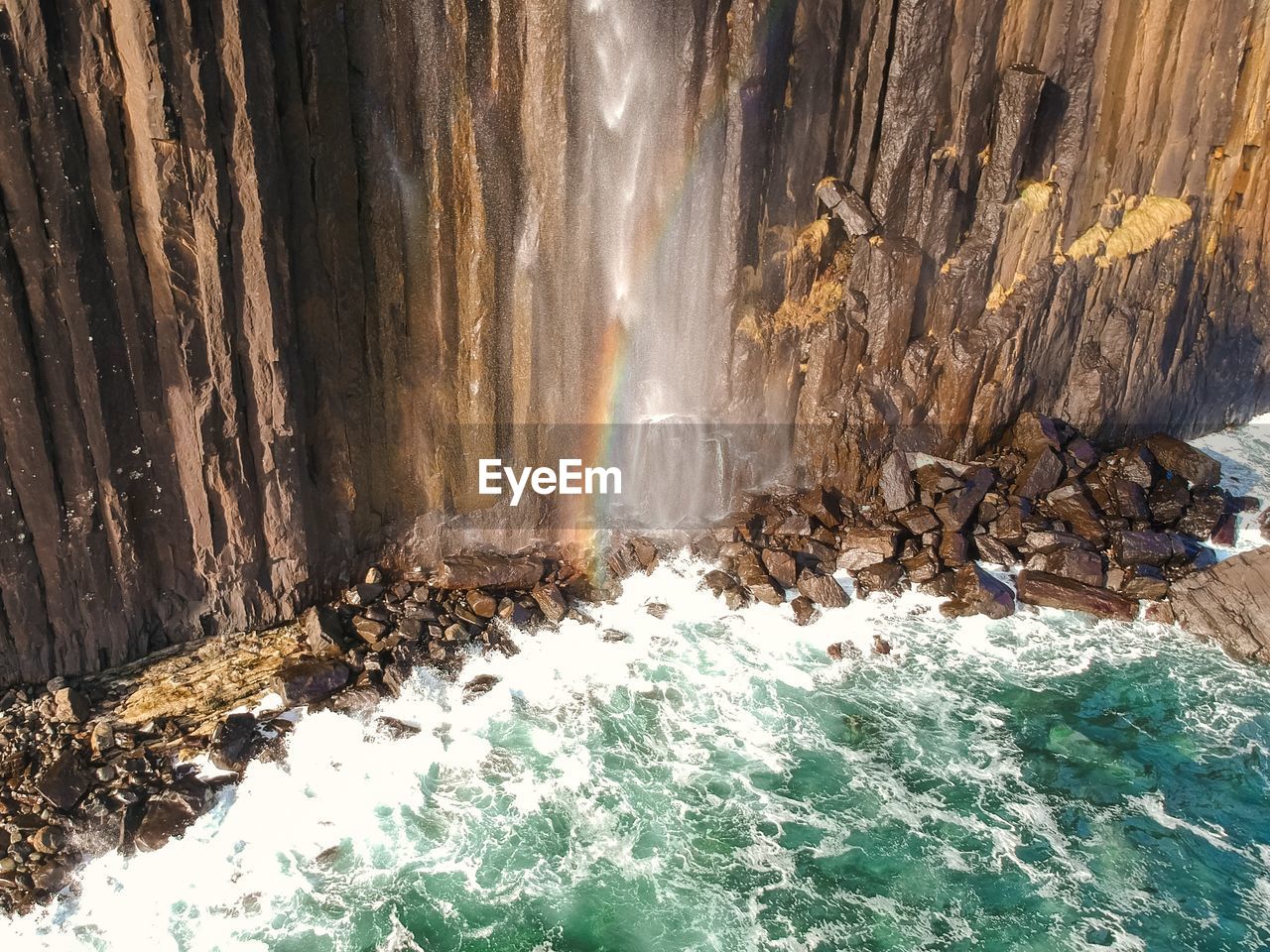 SCENIC VIEW OF WATERFALL BY SEA