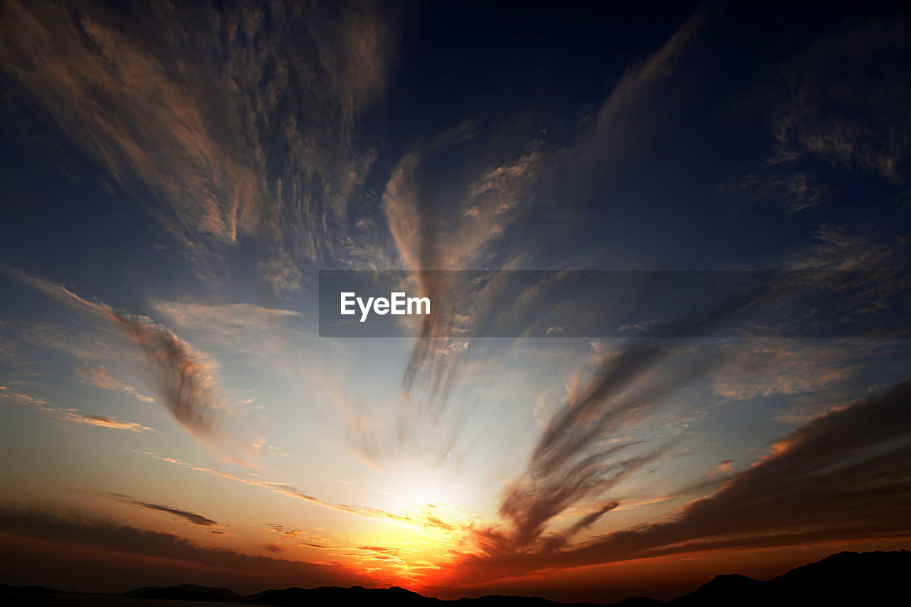 Low angle view of dramatic sky during sunset