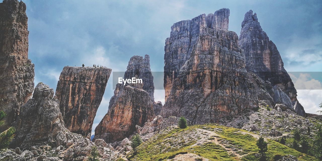 LOW ANGLE VIEW OF ROCK FORMATIONS AGAINST SKY