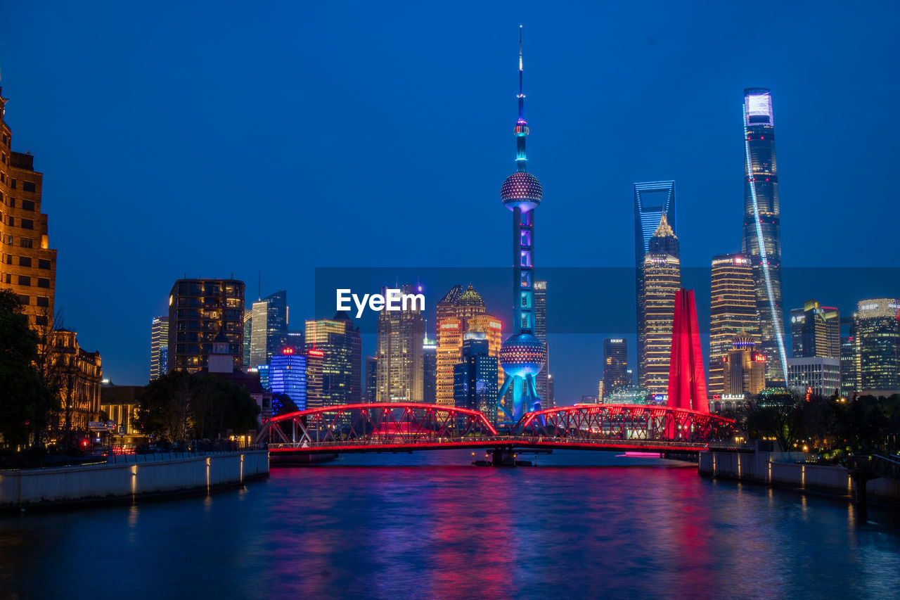 architecture, city, built structure, building exterior, skyline, office building exterior, skyscraper, building, illuminated, landscape, night, cityscape, landmark, urban skyline, travel destinations, water, sky, reflection, dusk, metropolitan area, metropolis, city life, nature, downtown district, tower, evening, horizon, residential district, downtown, river, urban area, office, no people, travel, waterfront, transportation, blue, outdoors, tourism, business, bridge, twilight, financial district, street, business finance and industry, lighting equipment, long exposure