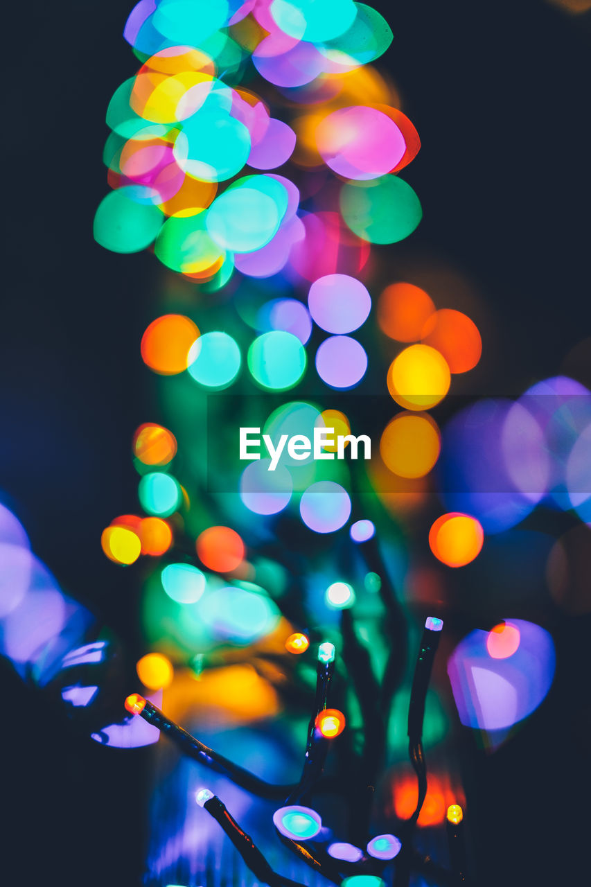 Defocused image of illuminated colorful lights at night