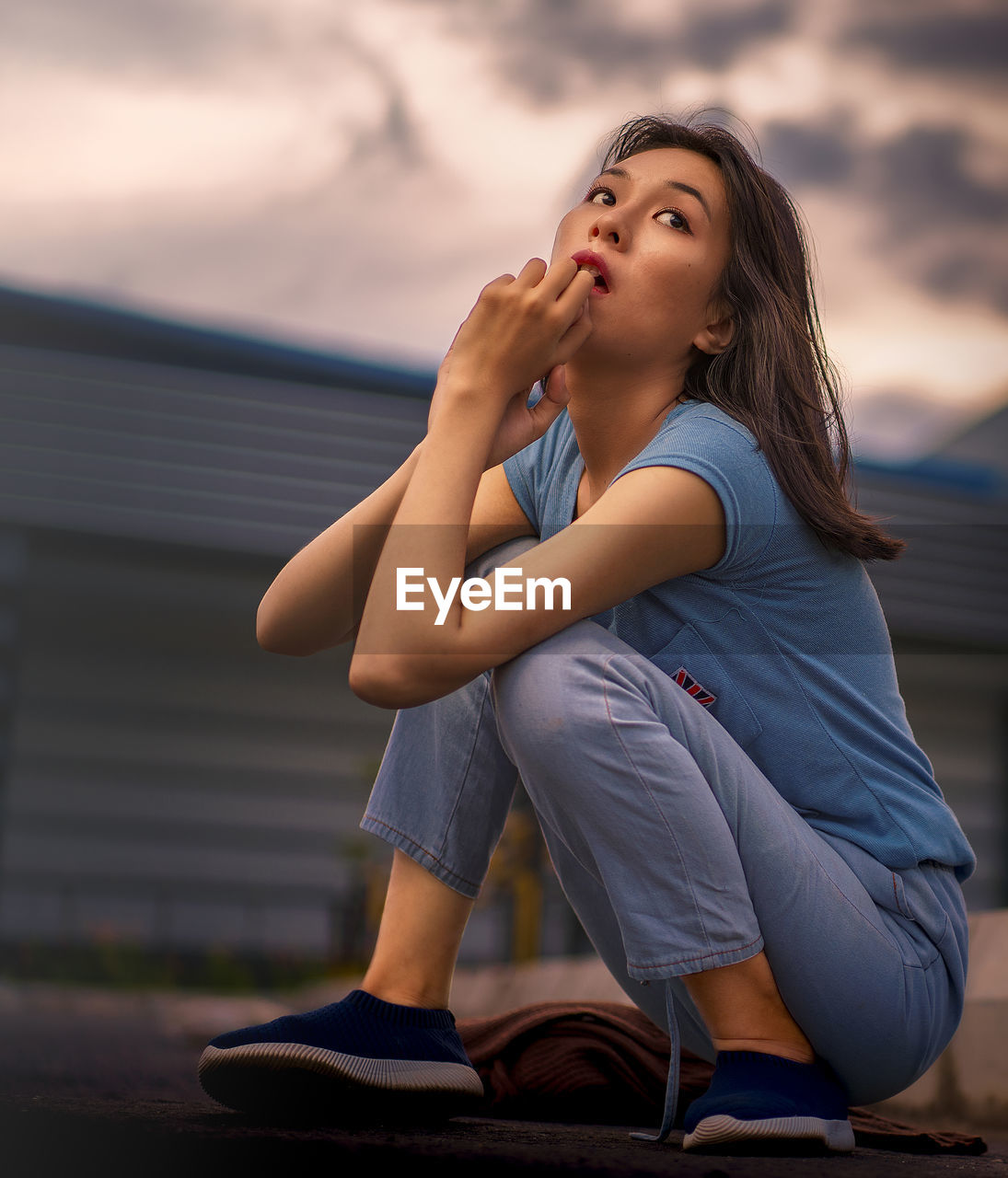 Young girl in the evening scenery. beautiful woman outside the house on a sunny day