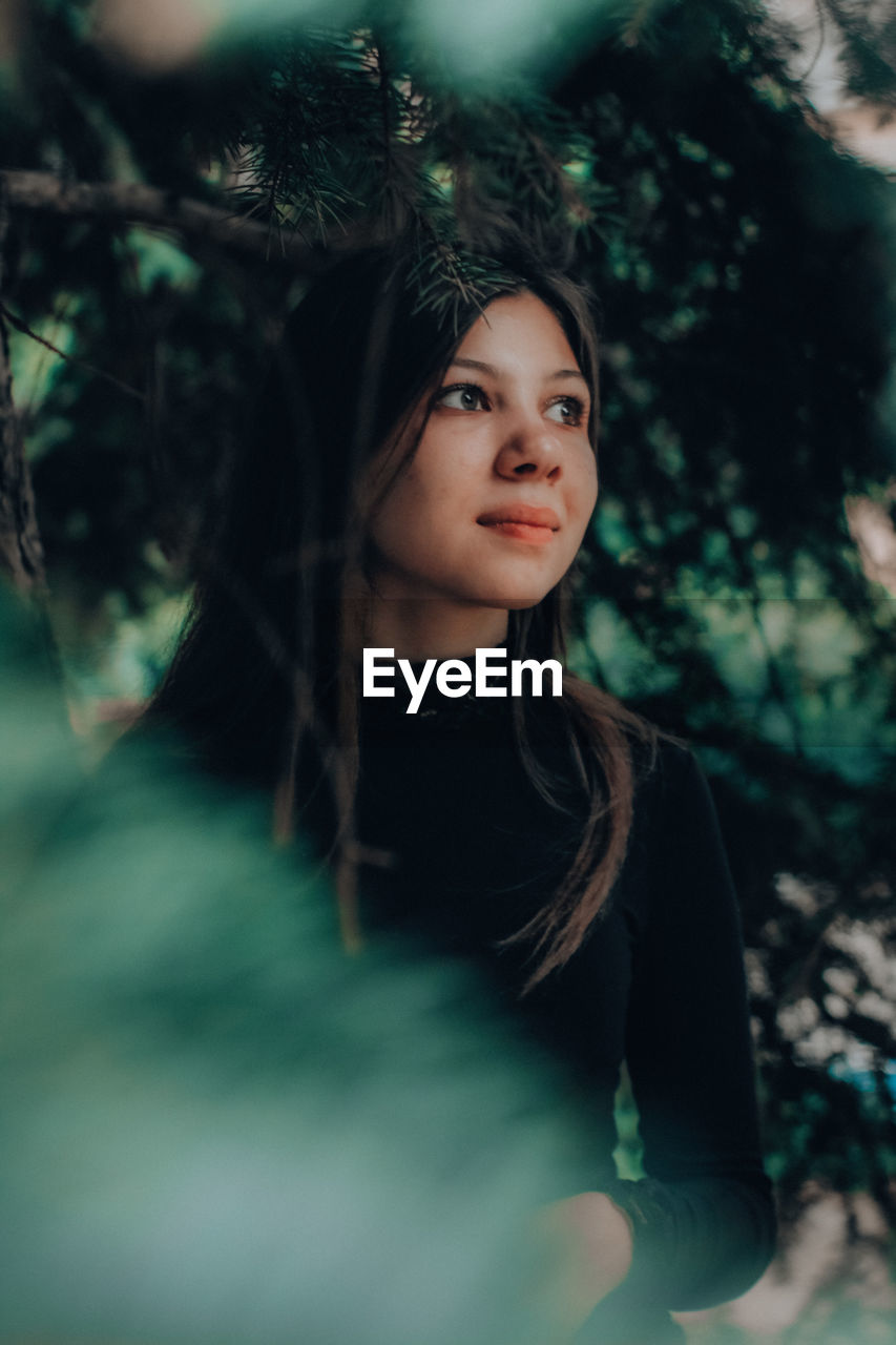 Portrait of young woman in forest