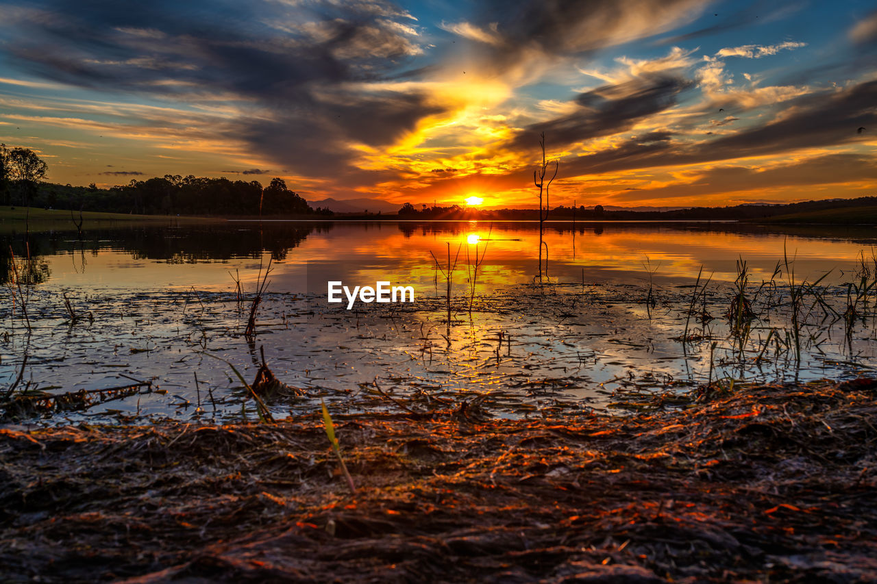 Scenic view of lake against sky during sunset