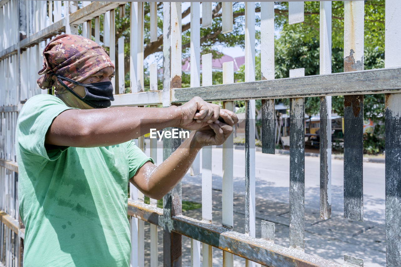 Man standing by railing