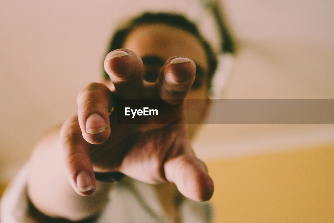 Close-up of man gesturing at home