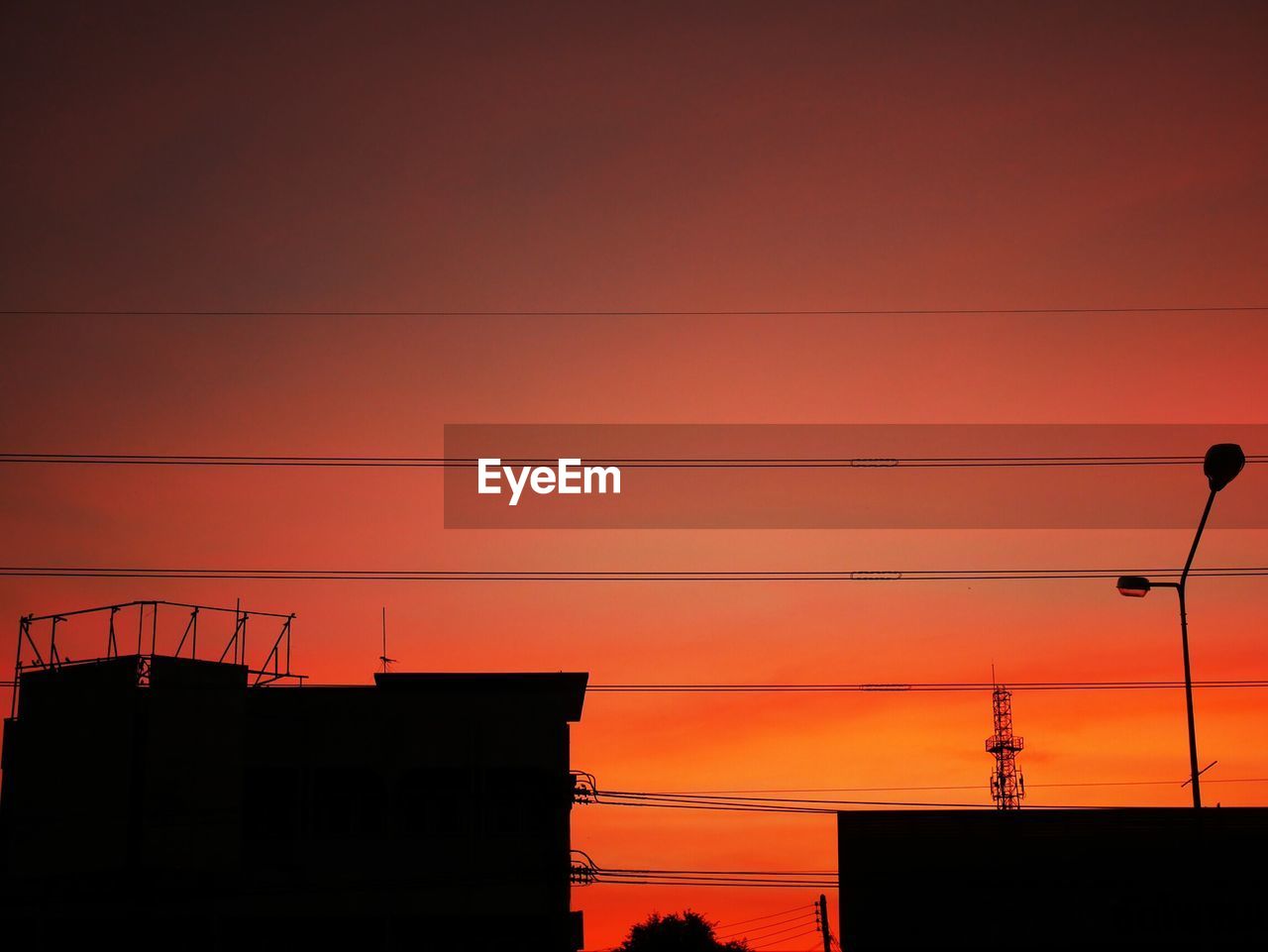 LOW ANGLE VIEW OF SILHOUETTE ELECTRICITY PYLON AGAINST SKY