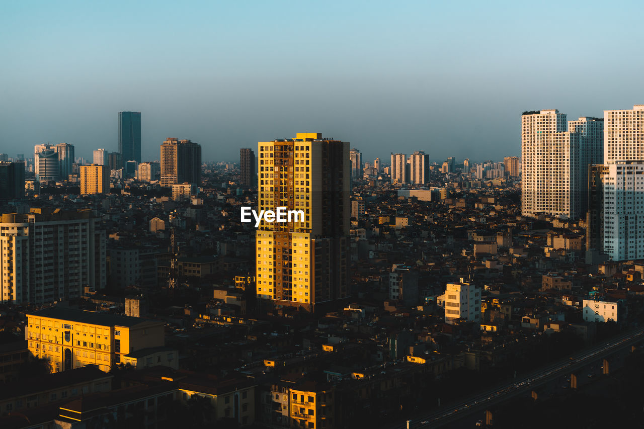 High angle view of modern buildings in city against sky