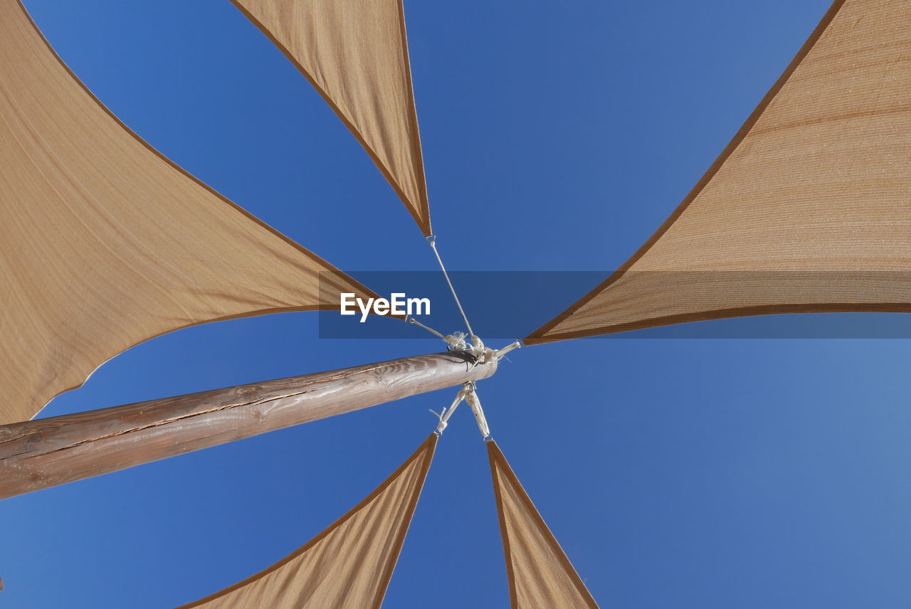 Low angle view of tent against clear blue sky