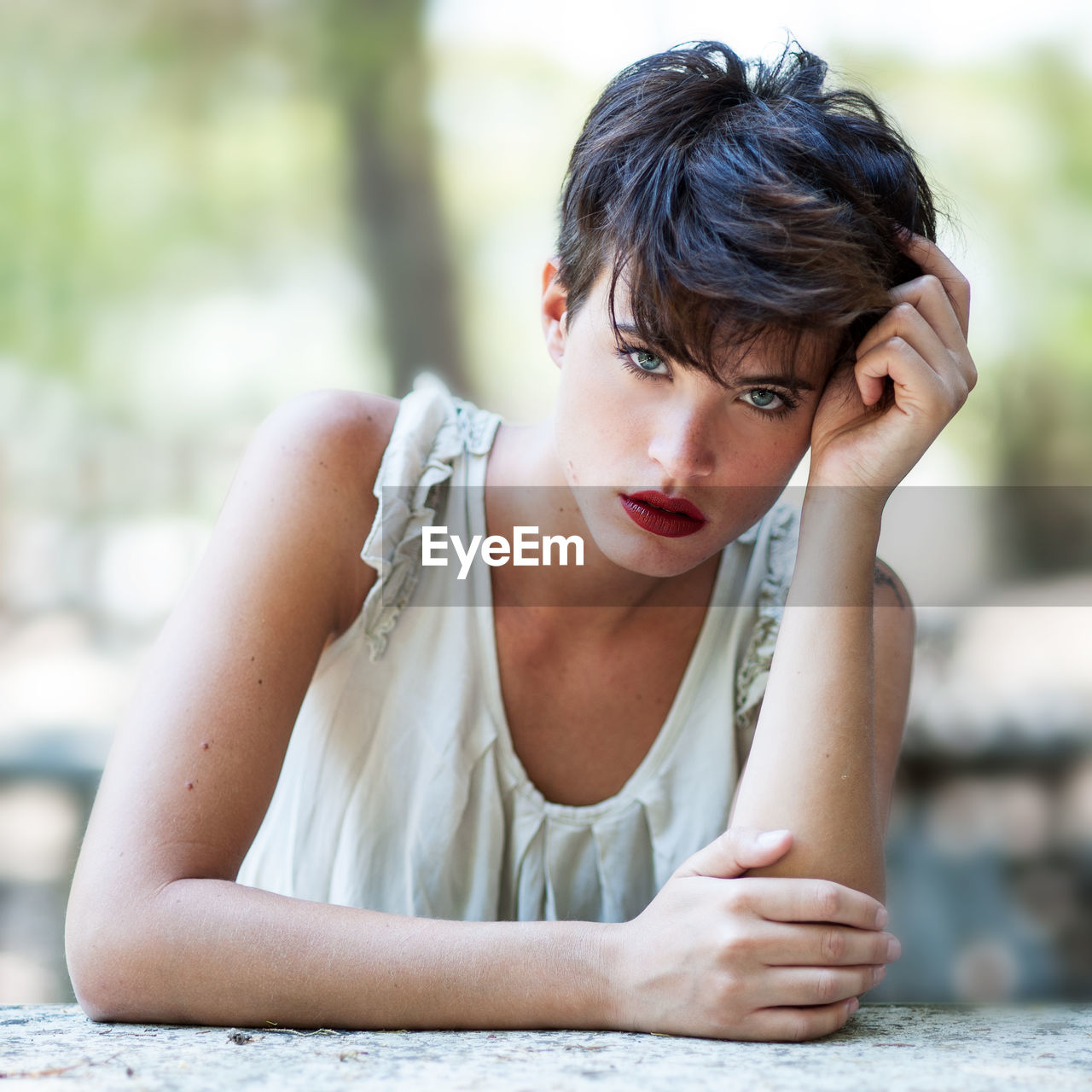 Portrait of young woman sitting outdoors