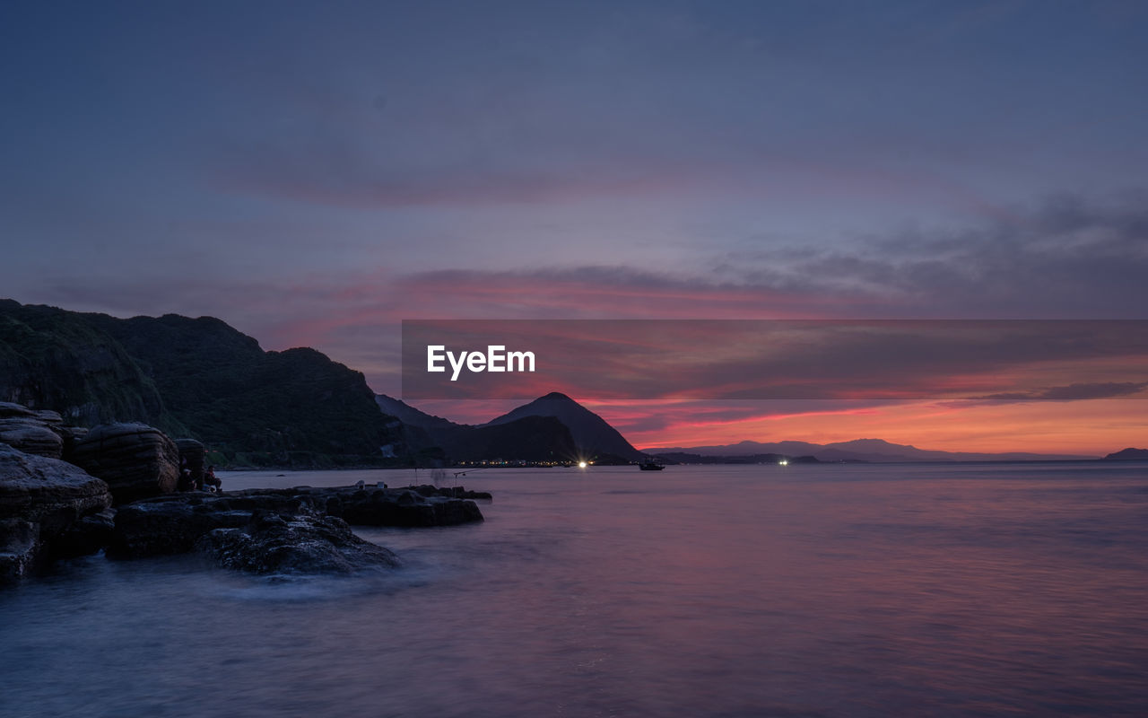 Scenic view of sea against sky at sunset