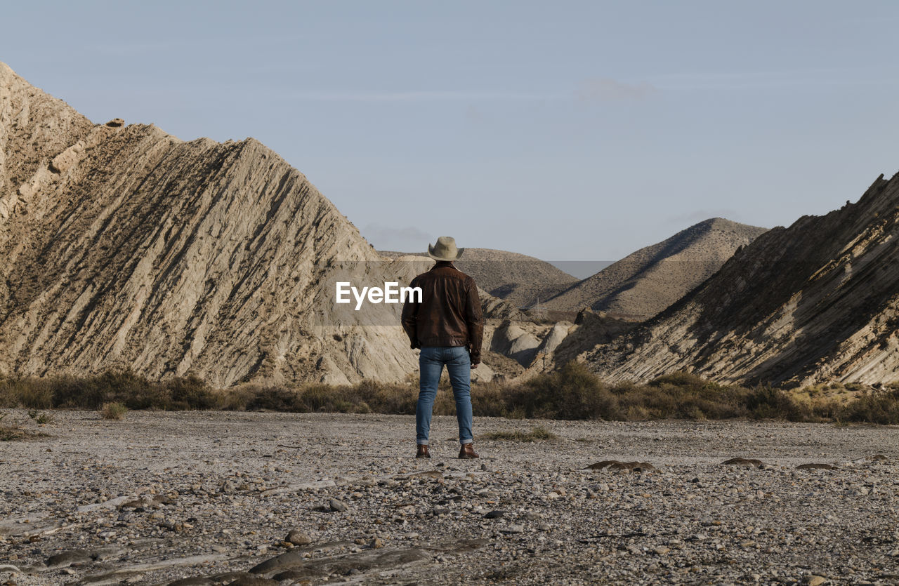 Adult man in cowboy hat in tabernas desert, almeria, spain