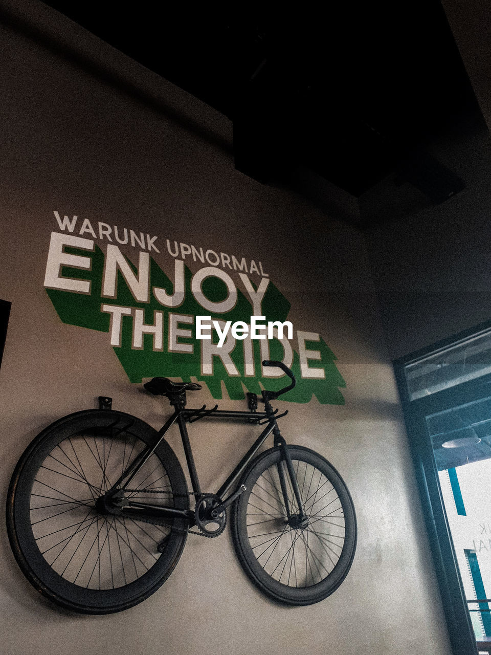 LOW ANGLE VIEW OF BICYCLE SIGN AGAINST WALL