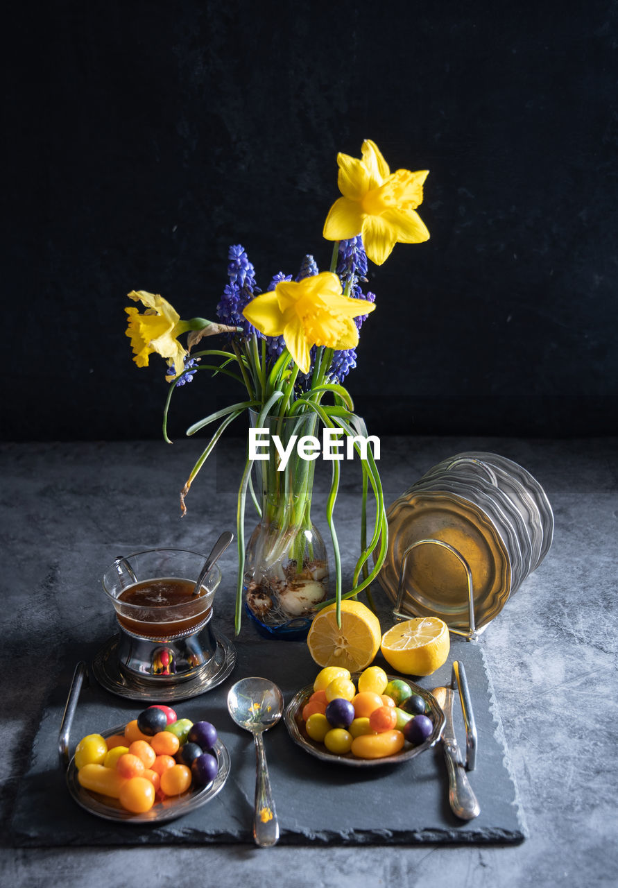 Sweet multi-colored candies on plates, beautiful junk food on a dark background