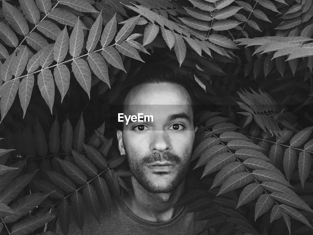 Close-up portrait of man against plants