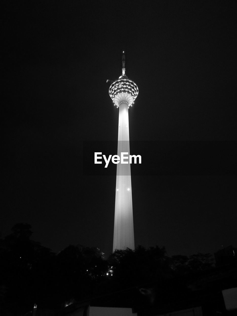 LOW ANGLE VIEW OF ILLUMINATED TOWER AGAINST SKY