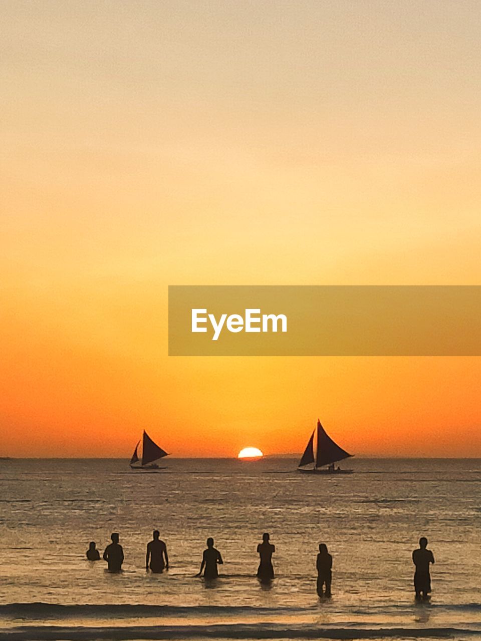 PEOPLE ON BEACH DURING SUNSET